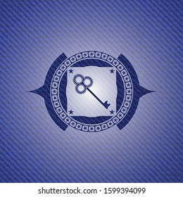 key icon inside emblem with jean background