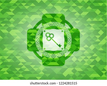 key icon inside green mosaic emblem