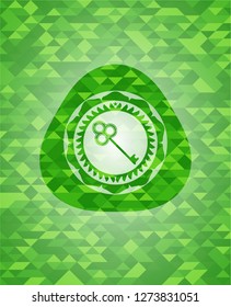 key icon inside green mosaic emblem