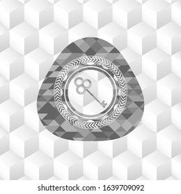 key icon inside grey badge with geometric cube white background