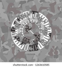key icon inside grey camouflage emblem