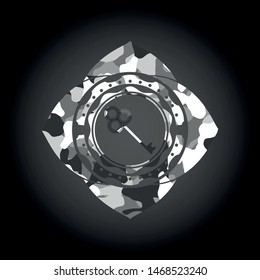 key icon inside grey camouflage emblem