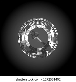 key icon inside grey camouflaged emblem