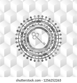 key icon inside grey emblem with geometric cube white background