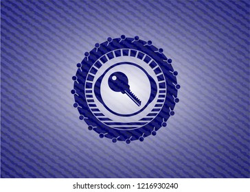 key icon inside jean or denim emblem or badge background