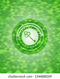 key icon inside realistic green emblem. Mosaic background