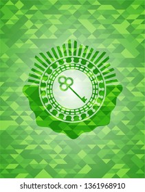 key icon inside realistic green mosaic emblem