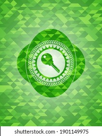 key icon inside realistic green emblem. Mosaic background. 