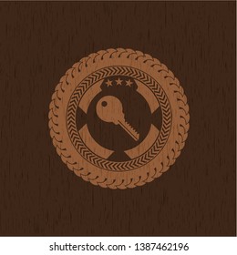 key icon inside realistic wood emblem