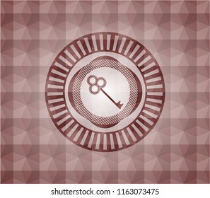 key icon inside red seamless emblem or badge with abstract geometric pattern background.