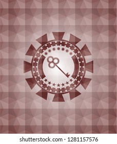 key icon inside red seamless geometric emblem.