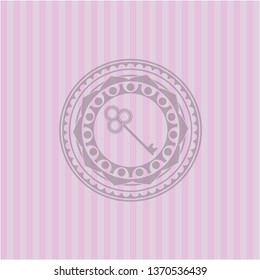 key icon inside retro style pink emblem