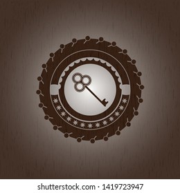 key icon inside retro style wood emblem