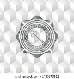 key icon inside retro style grey emblem with geometric cube white background