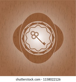key icon inside wood emblem