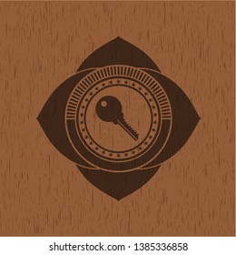 key icon inside wooden emblem