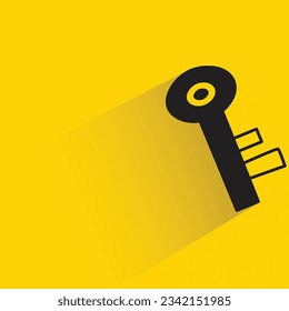 key with shadow on yellow background