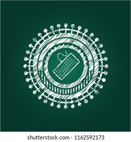 keyboard icon inside chalk emblem written on a blackboard