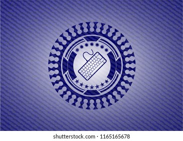 keyboard icon inside emblem with jean background
