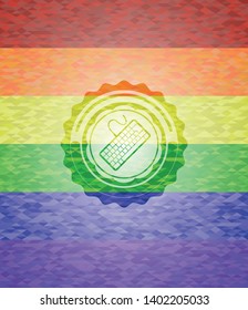 keyboard icon inside emblem on mosaic background with the colors of the LGBT flag