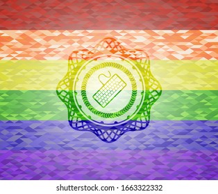 keyboard icon inside emblem on mosaic background with the colors of the LGBT flag