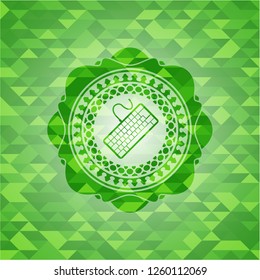 keyboard icon inside green emblem. Mosaic background