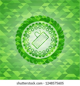 keyboard icon inside green mosaic emblem