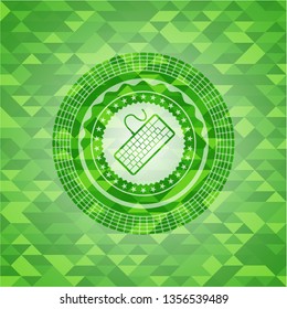 keyboard icon inside green mosaic emblem