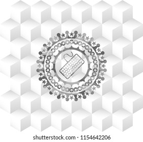 keyboard icon inside grey emblem with geometric cube white background