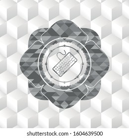 keyboard icon inside grey emblem with geometric cube white background