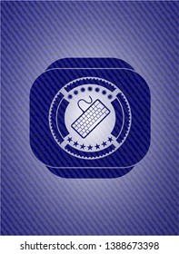 keyboard icon inside jean or denim emblem or badge background