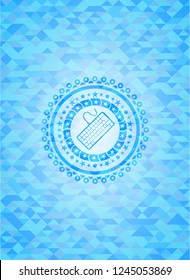 keyboard icon inside light blue emblem with triangle mosaic background