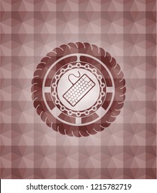 keyboard icon inside red seamless emblem or badge with abstract geometric pattern background.