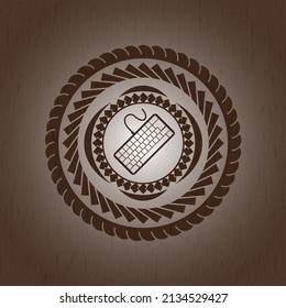 keyboard icon inside retro style wood emblem. 
