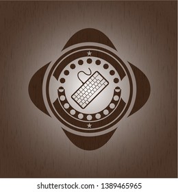 keyboard icon inside wood badge or emblem