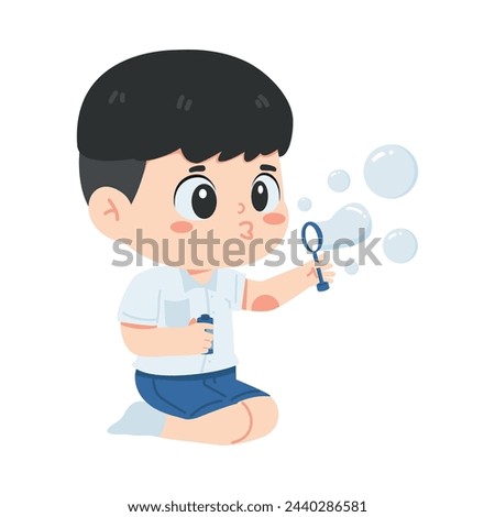 Kid boy student blowing soap bubbles