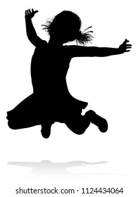 A kid or child in silhouette playing running jumping