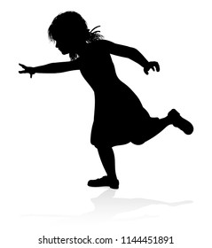 A kid or child in silhouette playing running jumping