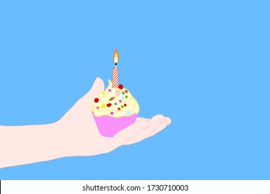 kid hand holding lovely cup cake with candle and flame. Birthday cake in the party which people can make a wish. holiday celebration concept. surprise and joyful with sweet whipped cream baked. 