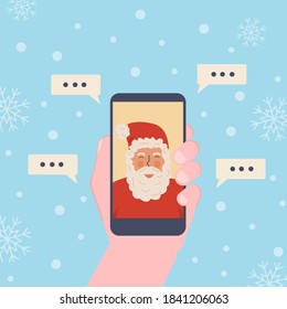Kid making video call with Santa Claus during Xmas. Hand holding smartphone. Chatting online using mobile app during pandemia for Christmas. Vector illustration with winter snowing background.