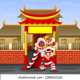 Kid playing chinese dragon dance in front of the temple