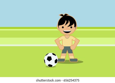 Kid playing soccer on green field with ball