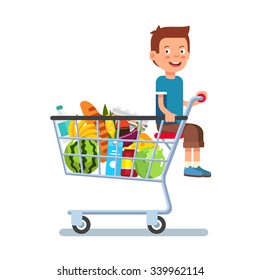 Kid sitting in a supermarket shopping cart full of groceries. Flat style vector illustration isolated on white background.