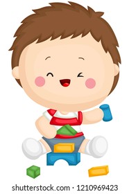 
Un niño sentado mientras juega bloques de construcción
