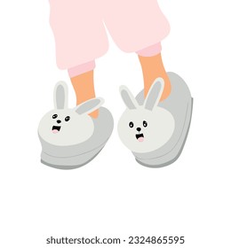 Kids feet in cute rabbit slippers. Comfortable home shoes, cozy childs footwear