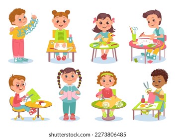 Kids paper craft. Children make decorations. Boys and girls glue applications of colored pages. Origami and garlands. Cut and paste sheets. Students sitting at tables