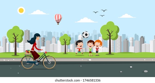Kids Playing with Ball in City Park with Woman Riding Bicycle on Asphalt Street