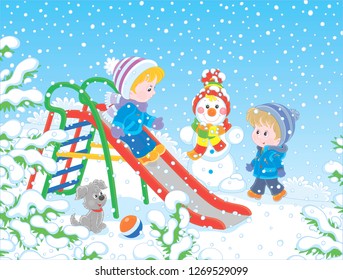 Kids playing on a toy slide on a snow-covered playground in a winter park, vector illustration in a cartoon style