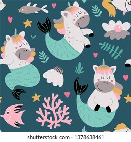 Kids seamless pattern with funny unicorn - mermaids, seashells and plants in vector on a blue background. Wrapping paper, textile, background fill.