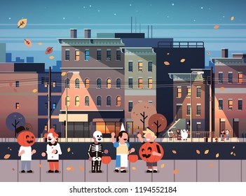 kids wearing monsters costumes walking night town holiday concept cityscape background tricks or treat happy halloween cartoon character full length horizontal flat vector illustration